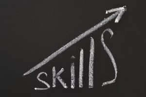 whiteboard showing a graph with "skills" increasing