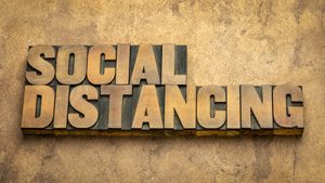 wooden blocks that say "social distancing"
